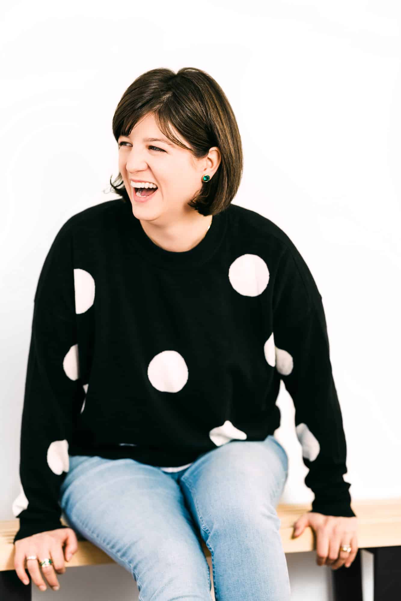 Personal Branding Woman in Polka dot sweater sitting on bench_Imiivo